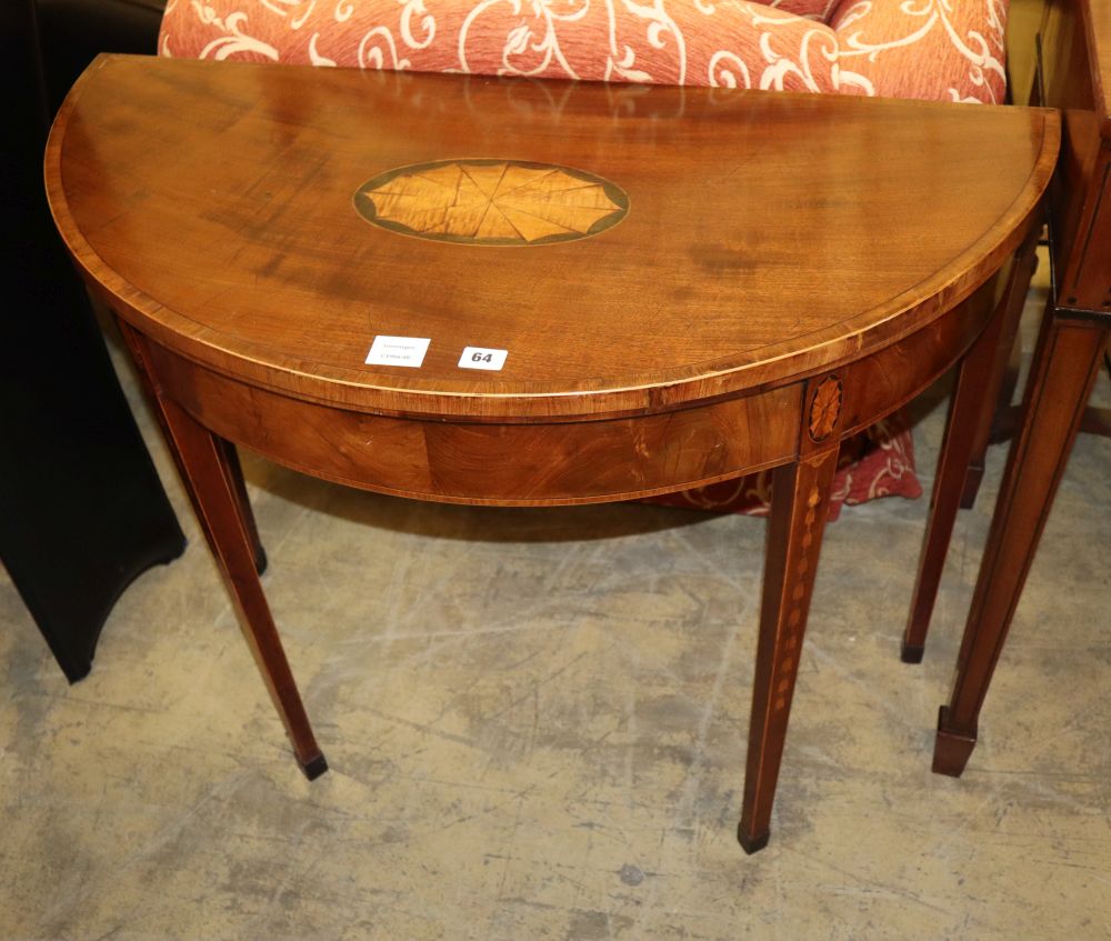 A George III mahogany and tulipwood banded D shaped folding card table, with husk and paterae inlay, W.92cm